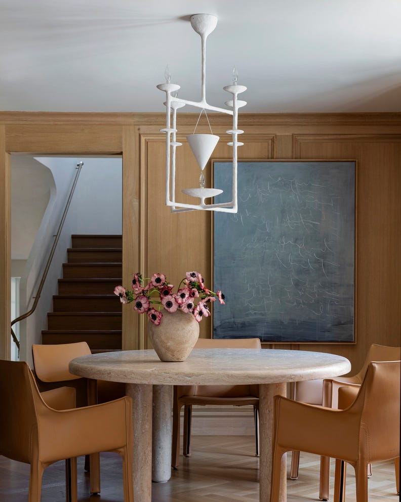 hold the line elegant design, neutral color palette chicago home designed by wendy labrum with michael abraham architecture inspiration english country estate with a contemporary twist dining room the nontraditional geometric plaster chandelier by alexandre log was found on 1stdibs art matthias fabre chairs cassina round dining table