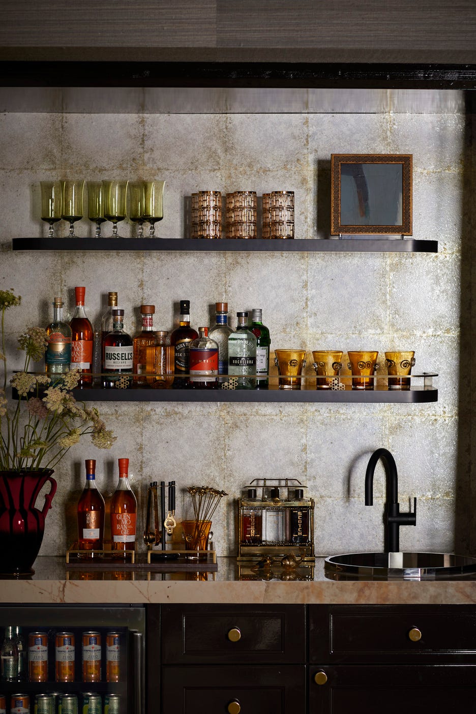 the lounge: rajni alex design @rajnialexdesign. elevated lounge vibe, textural elements, entertaining, multi purpose room, game room. home bar instead of traditional antique mirrored glass, alex chose a tile like, reflective wallcovering from zoffany as the bar’s backsplash. glassware: replacements, ltd. fixtures: kohler. shelf railing: architectural grille. countertop: dekton. whole home 2024. this year’s energy efficient home is in the conservation minded community of sprout, located on a private nature preserve in hendersonville, north carolina. the lounge: rajni alex design @rajnialexdesign. elevated lounge vibe, textural elements, entertaining, multi purpose room, game room. home bar instead of traditional antique mirrored glass, alex chose a tile like, reflective wallcovering from zoffany as the bar’s backsplash. glassware: replacements, ltd. fixtures: kohler. shelf railing: architectural grille. countertop: dekton. whole home 2024. this year’s energy efficient home is in the conservation minded community of sprout, located on a private nature preserve in hendersonville, north carolina.