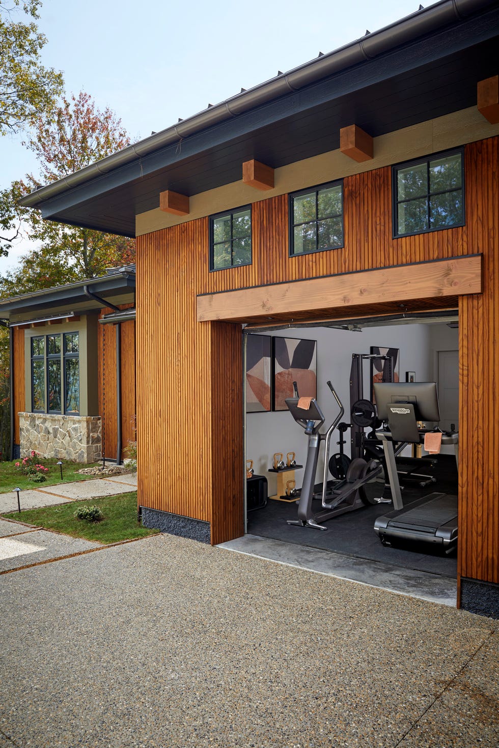 home gym iron house design ironhousedesign\, jim and tanya ryno garage gym\, mini circuit zones for strength training and cardio the elliptical machine and treadmill were both positioned to face out workout equipment art jaqui falkenheim, from minted mirror and bench wayfair professional paint blackened, farrow ball dumbbells and kettlebells pent whole home 2024 this years energy efficient home is in the conservation minded community of sprout\, located on a private nature preserve in hendersonville\, north carolina