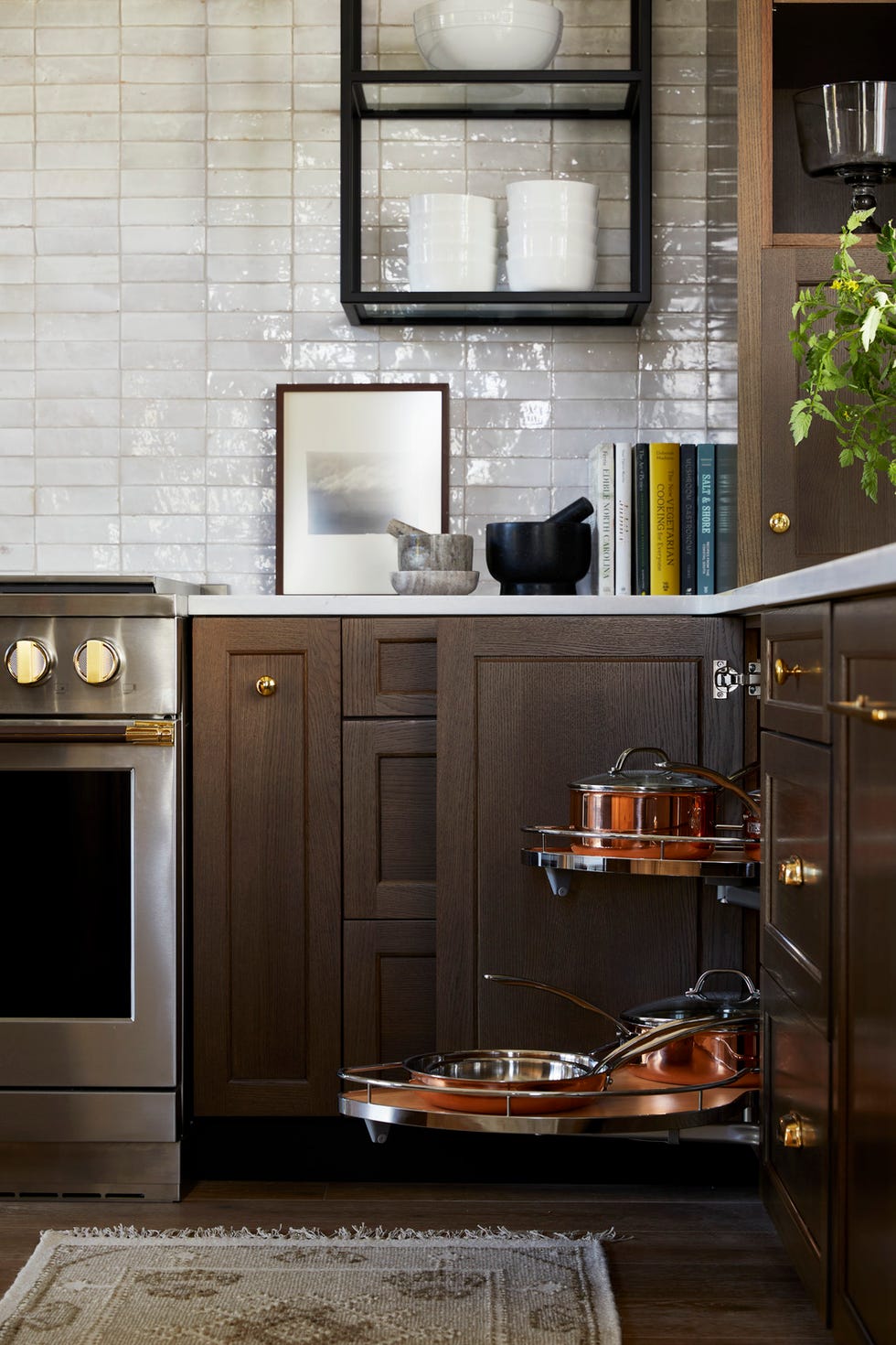the kitchen designed by kelsey leigh design co kelseyleighdesigncokelsey mcgregor natural finishes\, organic textures\, zellige tile\, a plastered range hood\, and complementary woods white oak and maple on the island and cabinetry open glass shelves house pretty everyday tableware\, while closed drawer storage keeps pots and pans out of sight but accessible includes dirty kitchen\, a hidden room accessed through french doors fabricated to look like cabinetry appliances monogram counter stools lee industries lighting visual comfort co roman shades hunter douglas fixtures kohler appliance hardware keeler brass company accessories wayfair professional art robert deem\, amanda phelps\, from minted\, christine carrier\, from serena lily whole home 2024 this years energy efficient home is in the conservation minded community of sprout\, located on a private nature preserve in hendersonville\, north carolina
