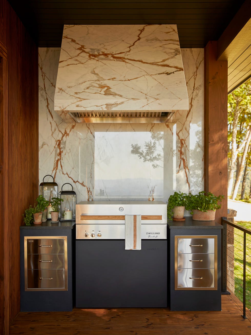 outdoor spaces curated nest curatednest, lina galvo and her partner erin coren outdoor living, patio, deck grilling zone anchored by a zwilling flammkraft grill and a striking, creamy, copper veined cosentino dekton onirika surface for the hood cover and backsplash, the cooking deck boasts an impressive outdoor kitchen worthy of a chef whole home 2024 this years energy efficient home is in the conservation minded community of sprout\, located on a private nature preserve in hendersonville\, north carolina