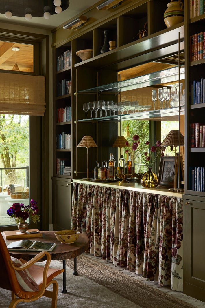 reading room: anne mcdonald design @anne_mcdonald_design. intimate, cozy retreat, custom millwork, luxurious solitude, antiqued mirror and brass shelf brackets from architectural grille, floating shelves, the bottom half of the built in is dressed with a floral skirt, softening the boxy architecture of the petite space. tactile elements, like a midcentury chair, 1970s limestone console, and silky goat hair rug, encourage guests to cross the threshold. to top it all off, a visual comfort co. chandelier with alabaster globes adds a touch of vintage glamour overhead. balancing the hard and soft here was all about a curated mix of textures. shelf hardware brackets and cafe curtain rod: architectural grille. lighting: visual comfort co. shades: hunter douglas. drapery: clarence house. rugs: safar (top), fibreworks (bottom). whole home 2024. this year’s energy efficient home is in the conservation minded community of sprout, located on a private nature preserve in hendersonville, north carolina. reading room: anne mcdonald design @anne_mcdonald_design. intimate, cozy retreat, custom millwork, luxurious solitude, antiqued mirror and brass shelf brackets from architectural grille, floating shelves, the bottom half of the built in is dressed with a floral skirt, softening the boxy architecture of the petite space. tactile elements, like a midcentury chair, 1970s limestone console, and silky goat hair rug, encourage guests to cross the threshold. to top it all off, a visual comfort co. chandelier with alabaster globes adds a touch of vintage glamour overhead. balancing the hard and soft here was all about a curated mix of textures. shelf hardware brackets and cafe curtain rod: architectural grille. lighting: visual comfort co. shades: hunter douglas. drapery: clarence house. rugs: safar (top), fibreworks (bottom). whole home 2024. this year’s energy efficient home is in the conservation minded community of sprout, located on a private nature preserve in hendersonville, north carolina.