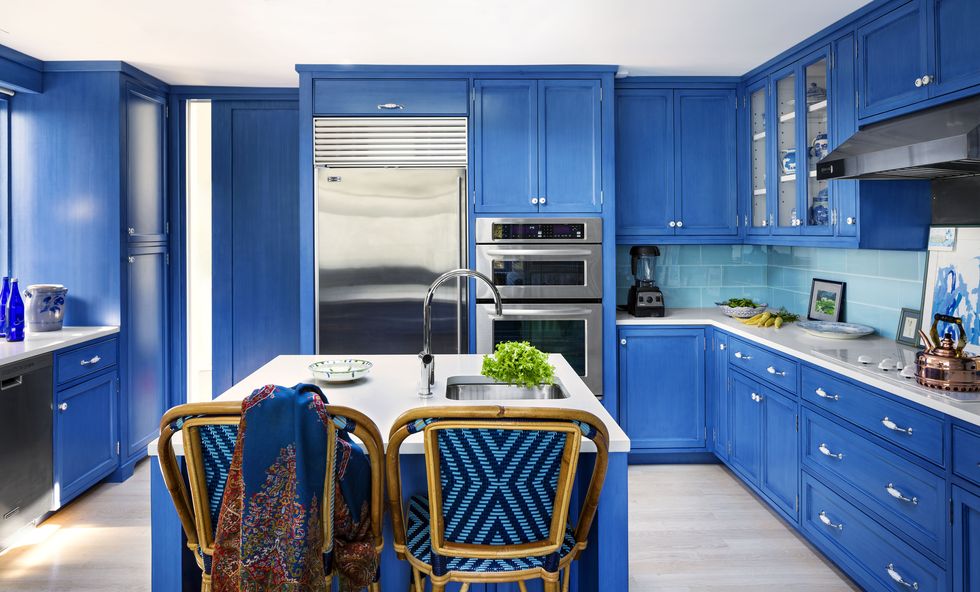 cobalt blue kitchen with woven bar stools