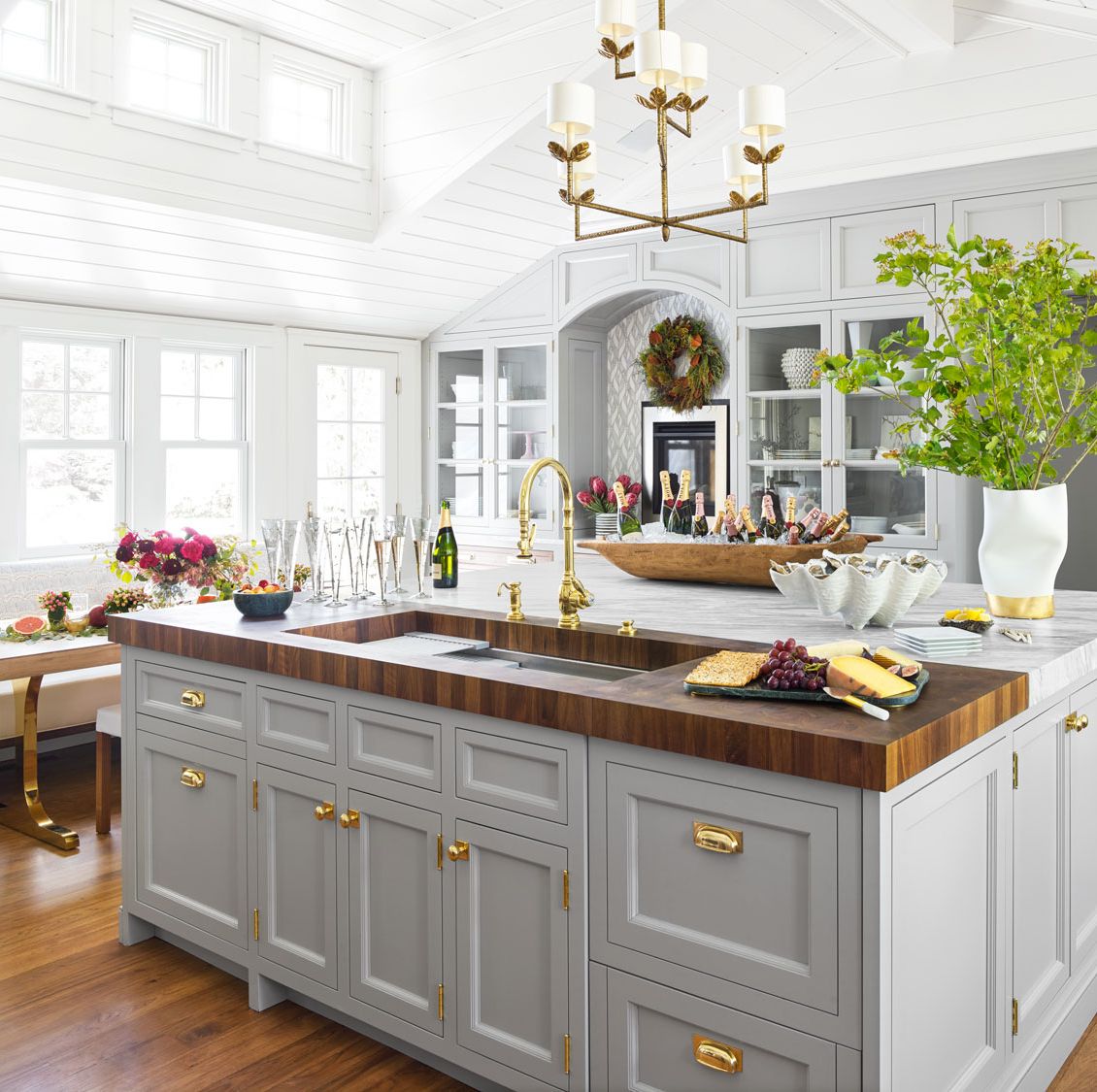 A luxurious white and blue kitchen with gold hardware, Bosch and