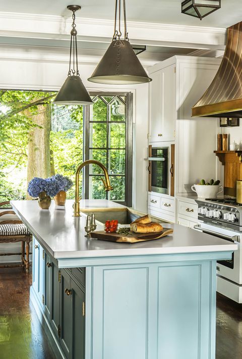 kitchen with soft blue painted island and custom window