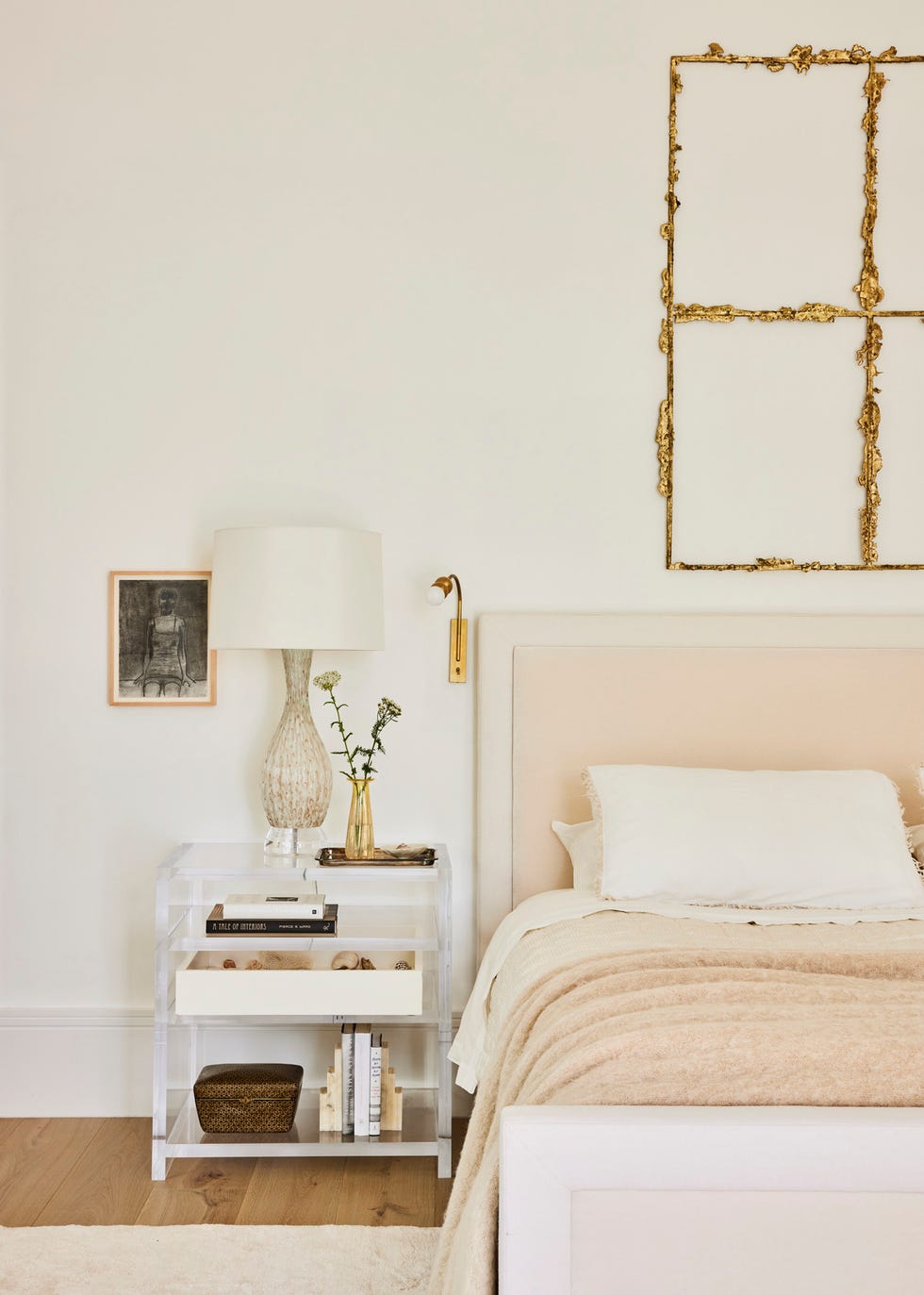 designer kristin fine’s 12 year old modern farmhouse in westport, connecticut. primary bedroom. bronze sculpture by tania pérez córdova, crowns a the 1818 collective bed in dedar fabric. sconce: garde. drawing: merlin james. nightstand: custom, antony todd. lamp: vintage murano. bedding: society limonta (linens); hermès (blanket).