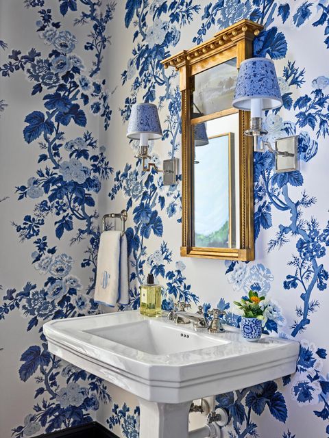 white sink and walls covered in blue flower wallpaper