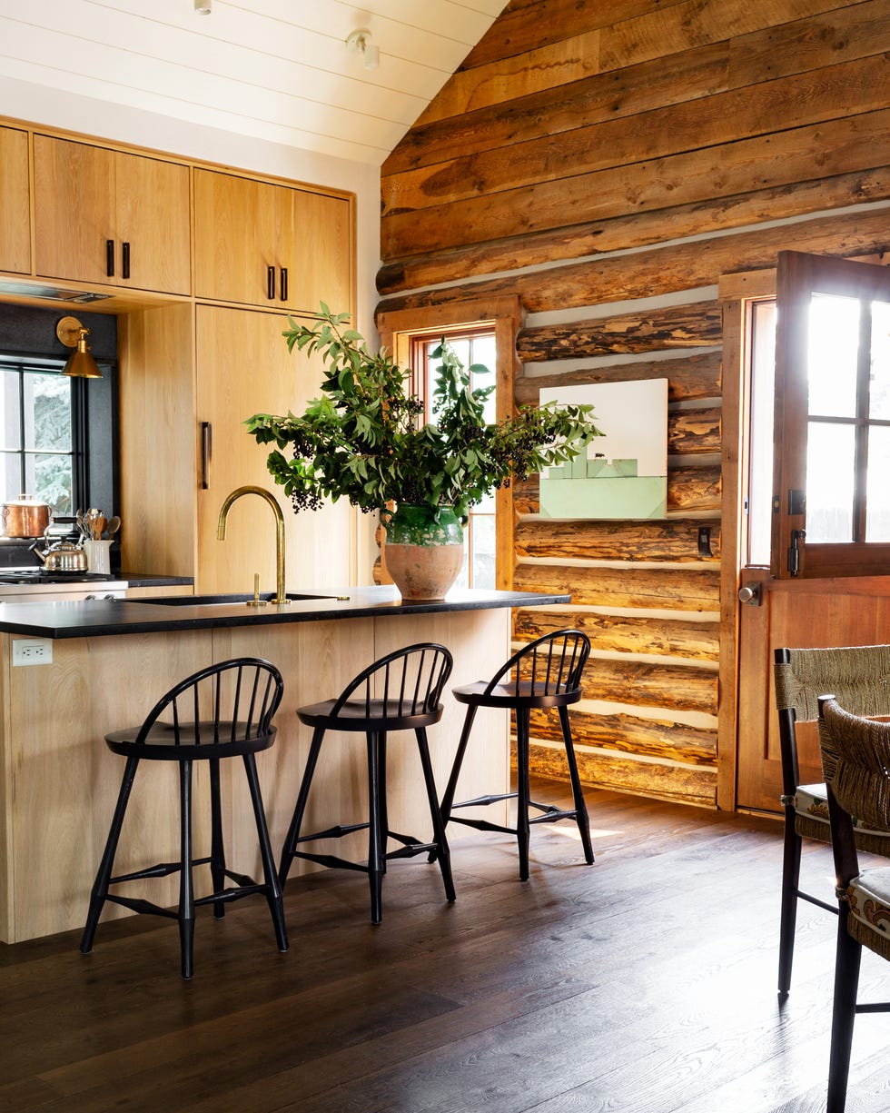 Emily Janak Teton Mountains, Jackson Hole, Wyoming Home Kitchen Oakstone is a living finish, Janak says, so you have to be OK with it chipping and staining. Totally appropriate for a cabin Stool OG Studio Faucet Kallista pulls Rocky Mountain Hardware Wall sconce Mark D. Sikes for Hudson Valley Lighting Art Craig Spankie