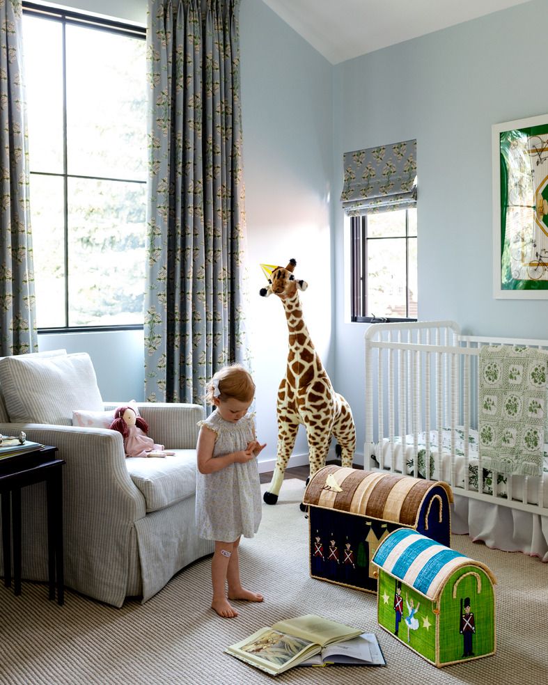 emily janak teton mountains, jackson hole, wyoming home nursery anchored by a cool paint, iceberg by benjamin moore, the classic design of their daughter’s room has verve shade and curtain fabric lulie wallace crib jenny lind for davinci, with a biscuit home skirt chair highland house
