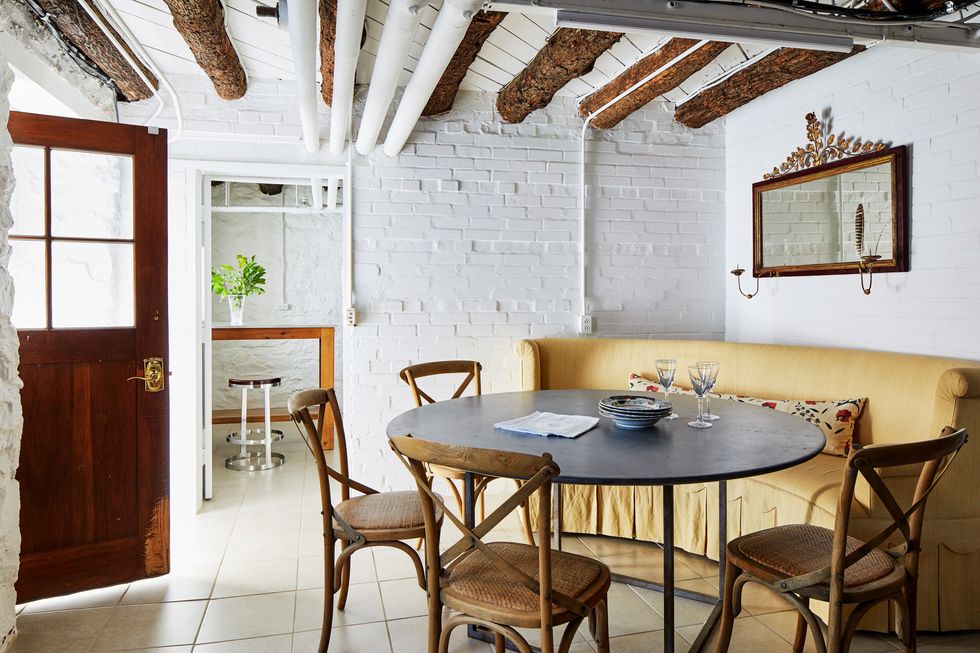 dining room with painted white brick wall