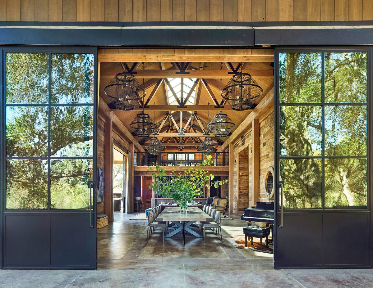 sliding doors open to show spaces barn with table in the center