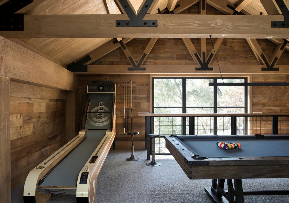 skee ball and pool table in a loft