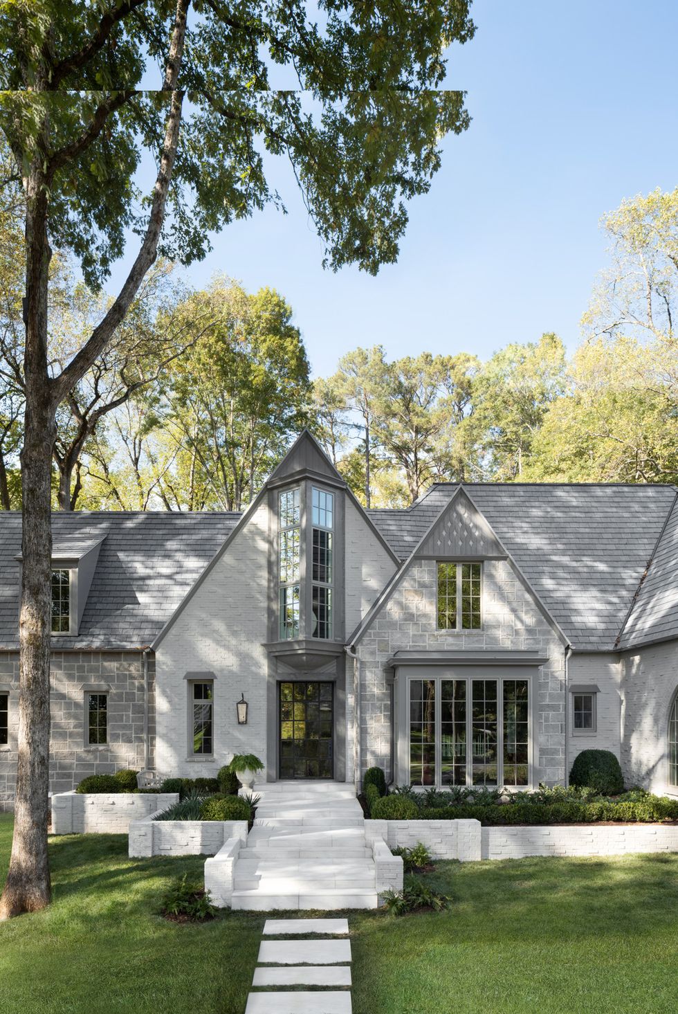 exterior the facade was updated with architectural windows from pella and paint in mole's breath and purbeck stone by farrow ball a new pivoting steel door with a schlage smart lock grants guests access from afar 5th annual whole home