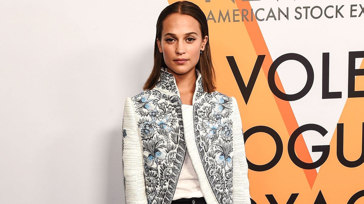 Alicia Vikander carries a large Louis Vuitton bag as she arrives