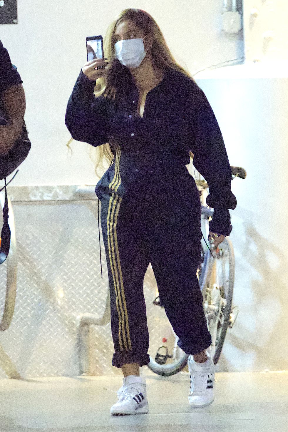 exclusive beyonce was spotted out in nyc over the weekend, as she took part in an adidas photoshoot, for her upcoming collaboration with the brand queen bey was inside the manhattan studio for 8 hours, before emerging in a black and gold tracksuit she showed off her fuller frame, and curvy figure, all while taking selfies on her iphone the star opted not to use the front camera, instead showing off a new technique, as she walked alongside her tall bodyguard 23 aug 2020 pictured beyonce photo credit mega themegaagencycom 1 888 505 6342