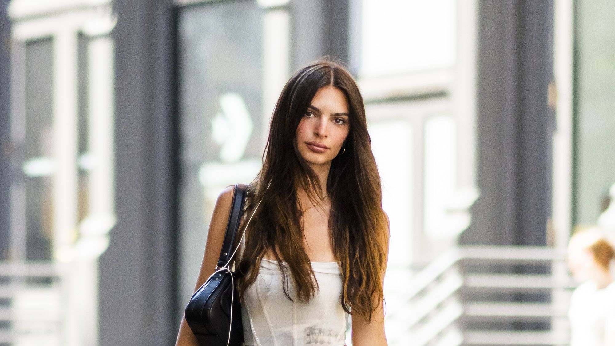 Emily Ratajkowski Pairs A Denim Skirt with Cowboy Boots with Her