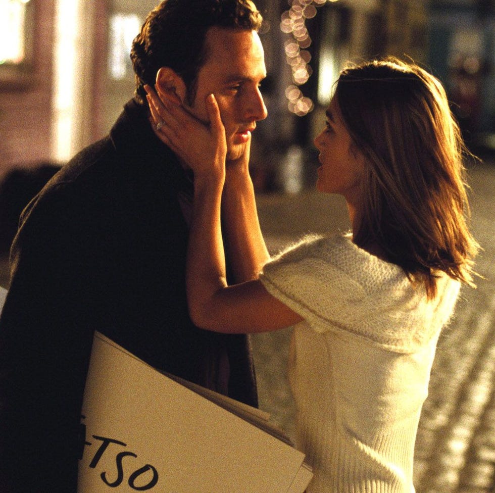 romantic interaction between a couple in a cobblestone street romantic interaction between a couple in a cobblestone street
