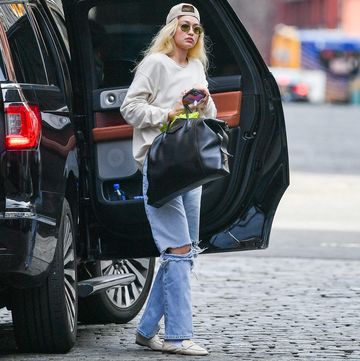 03292023 exclusive gigi hadid is pictured stepping out in new york city the sighting comes amid rumors that her ex, zayn, is dating selena gomez gigi carried a givenchy bag and wore a backwards cap, off white sweater, ripped jeans, and loaferssalestheimagedirectcom please bylinetheimagedirectcomexclusive please email salestheimagedirectcom for fees before use