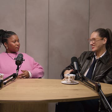 women engaged in a discussion at a podcast setup women engaged in a discussion at a podcast setup