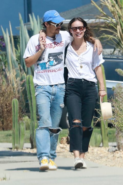 harry styles and olivia wilde in ripped denim and white shirts