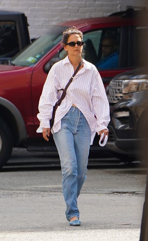 08102022 exclusive katie holmes looks casual as she steps out for a stroll in new york city the 43 year old american actress kept cool as she made her way through solo wearing an oversized striped dress shirt paired with distressed denim jeans, blue shoes, and dark shadessalestheimagedirectcom please bylinetheimagedirectcomexclusive please email salestheimagedirectcom for fees before use