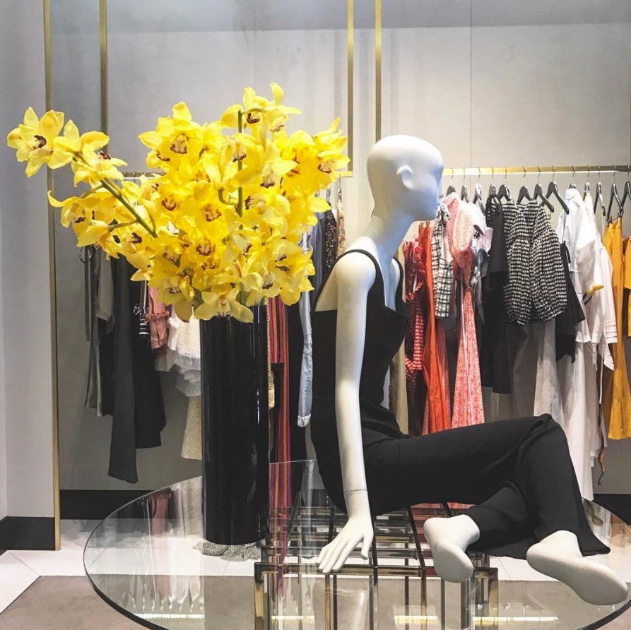 Display window, Yellow, Mannequin, Display case, Retail, Artificial flower, Fashion, Boutique, Flower, Fashion design, 