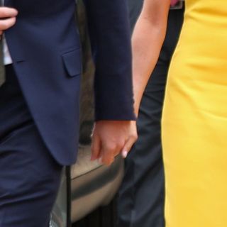 Suit, Yellow, Formal wear, Tuxedo, Gesture, Interaction, Hand, Outerwear, Holding hands, Dress, 