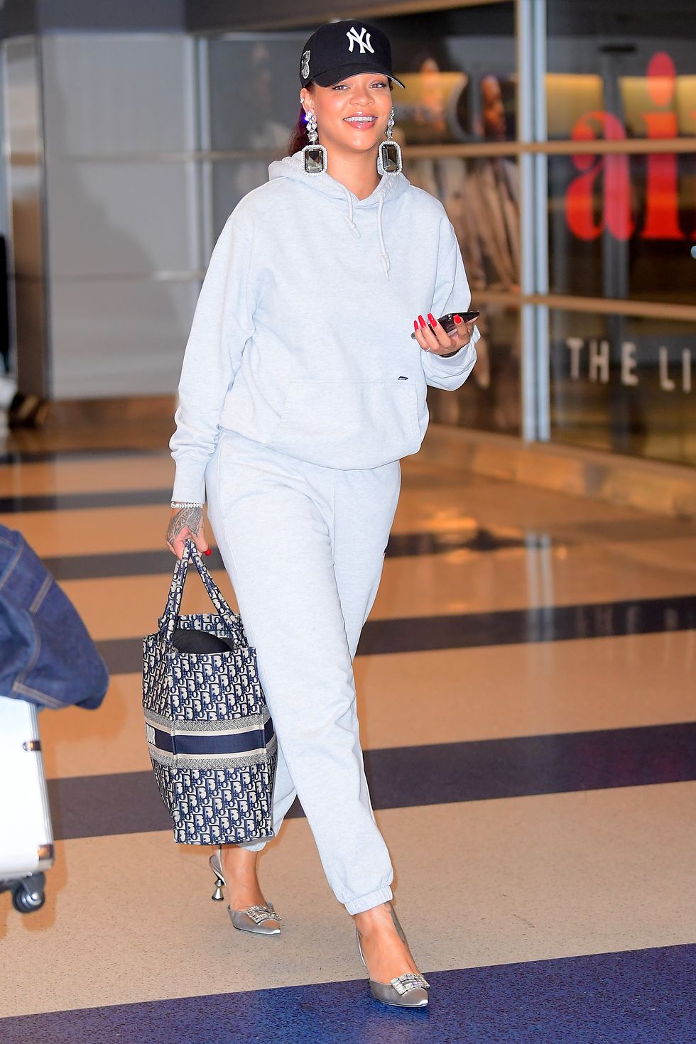 EXCLUSIVE: Rihanna Pairs Manolo Blahnik Heels With A Grey Sweatsuit As She Jets Into NYC For Her Pop Up Shop Opening