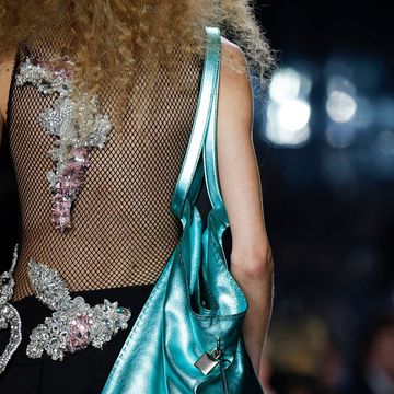 three models carry bags on the spring 2023 runways in a roundup of spring 2023 bag trends to know