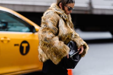 Fur, Fur clothing, Street fashion, Clothing, Yellow, Fashion, Textile, Outerwear, Coat, Footwear, 