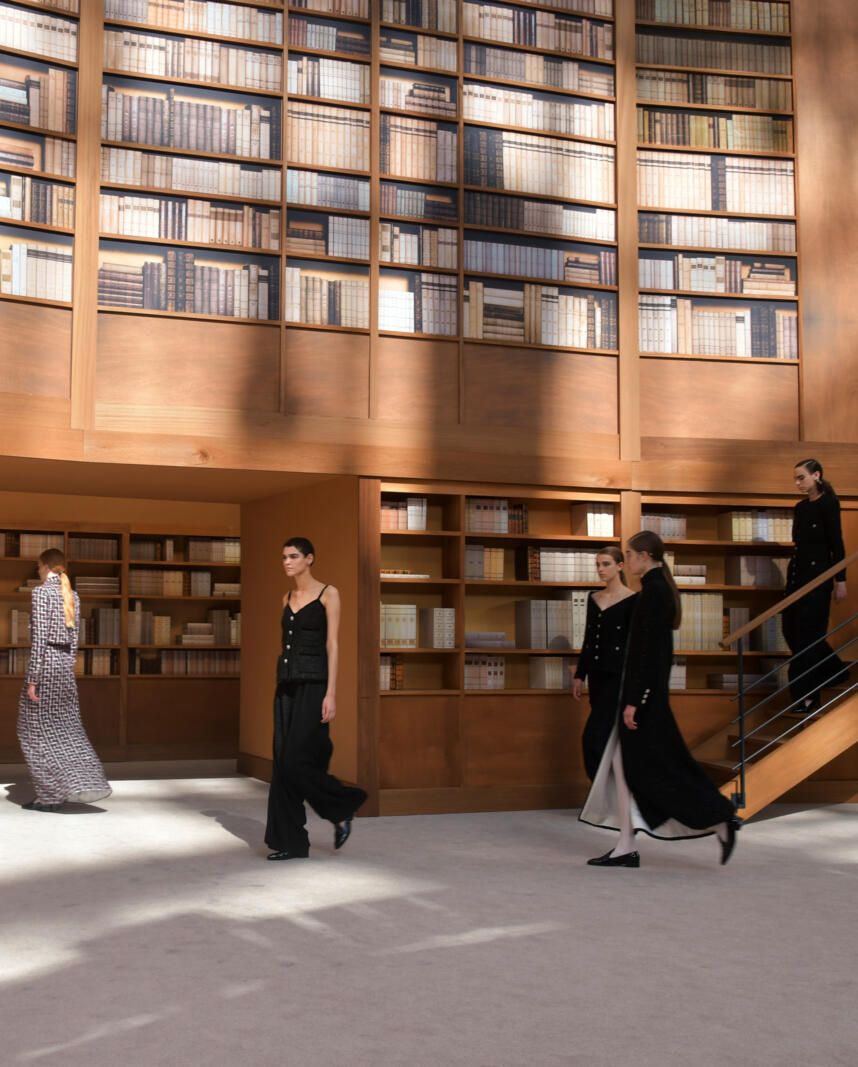 a group of people dancing in a library