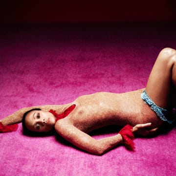 reclining figure adorned with embellishments on a vibrant pink background reclining figure adorned with embellishments on a vibrant pink background