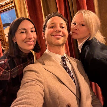 group selfie taken indoors with colorful drapes and artwork in the background group selfie taken indoors with colorful drapes and artwork in the background