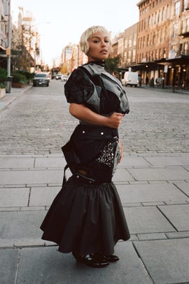 fashionable model showcasing a unique outfit on a city street