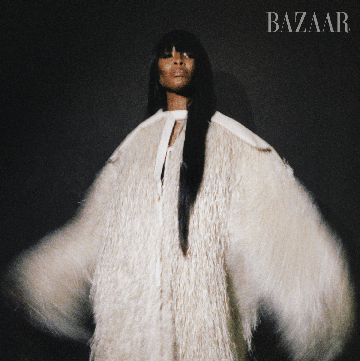 a close up on naomi campbell's face, with her long straight hair in bangs