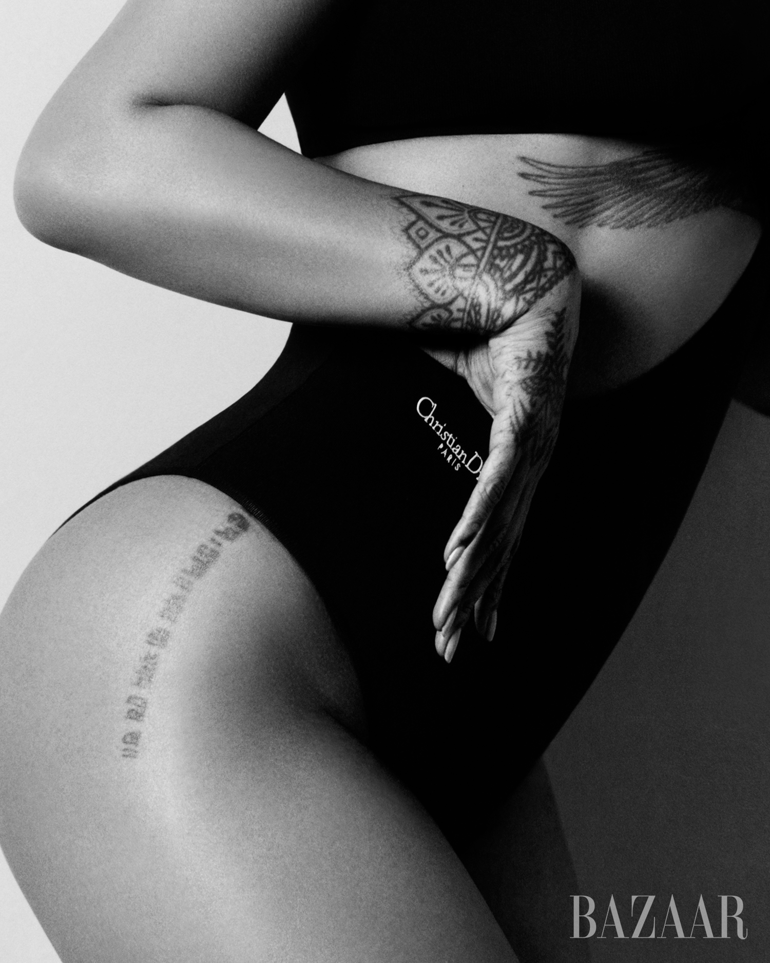 fashionable pose highlighting body art and designer wear