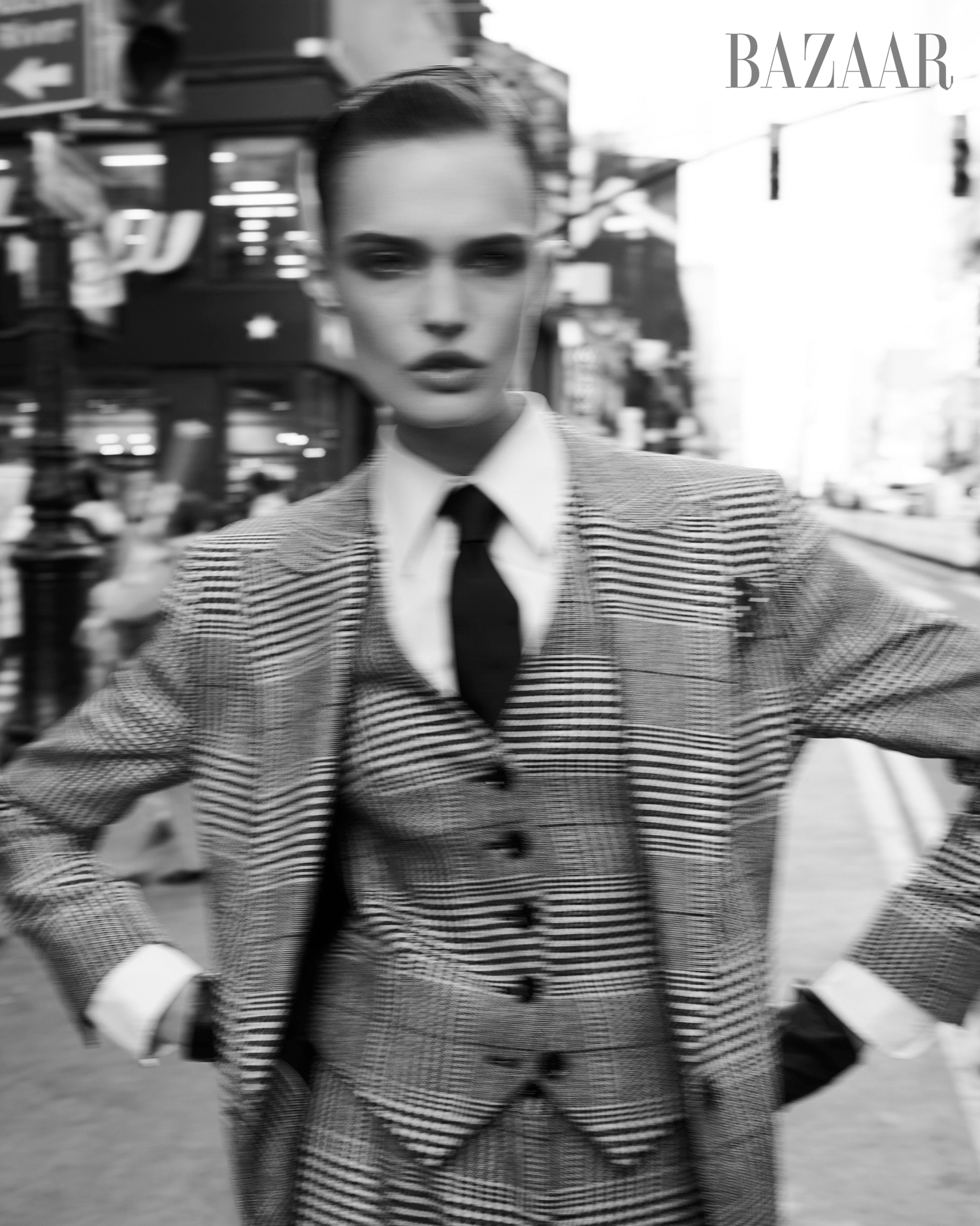 man dressed in a stylish checkered suit on a city street