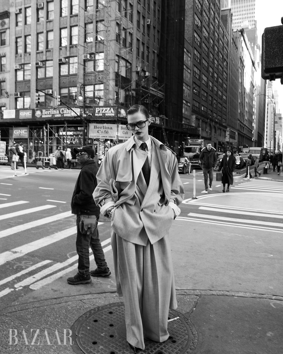 a person dressed in oversized fashion walking in an urban environment