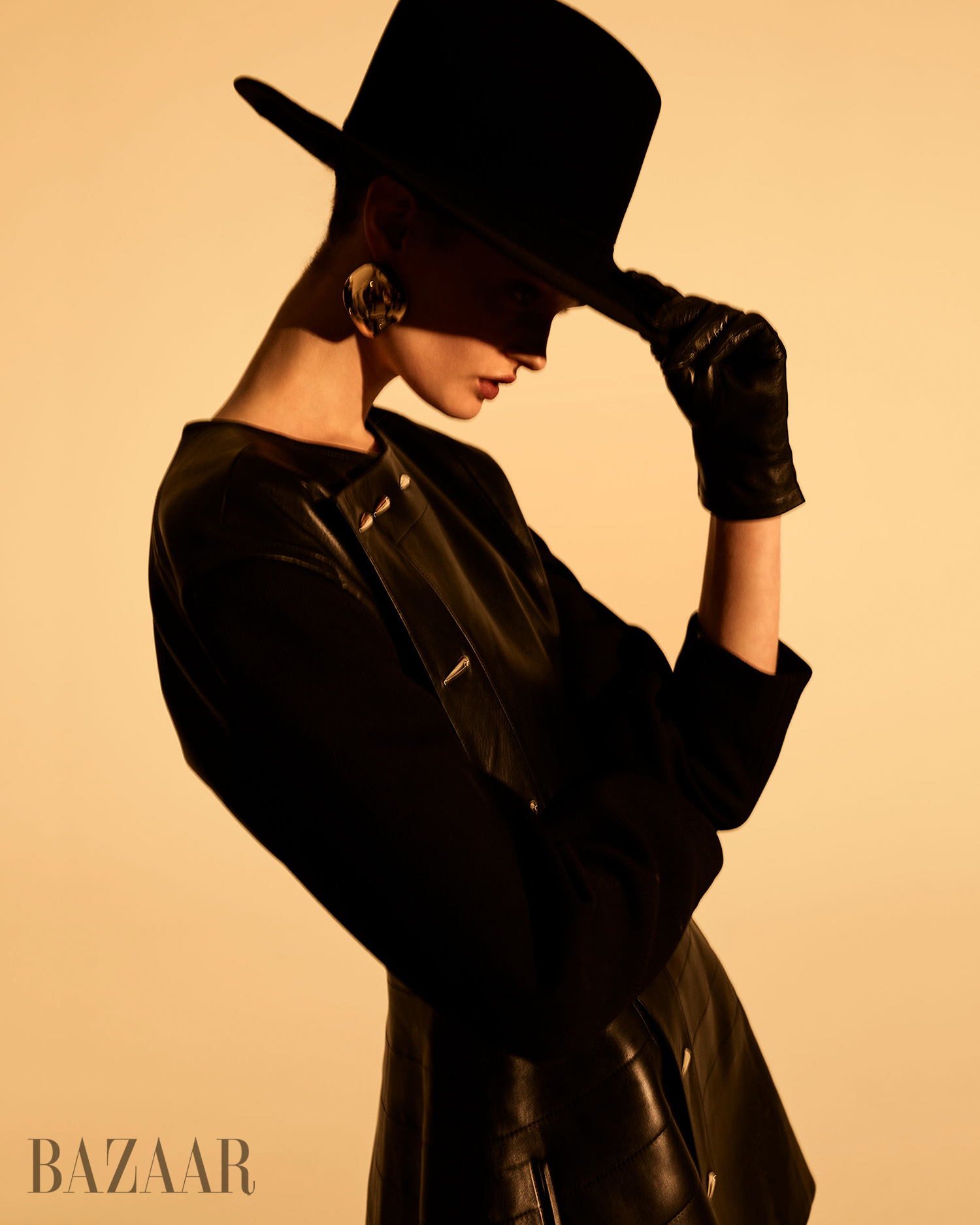 a fashion model wearing a stylish black ensemble with accessories