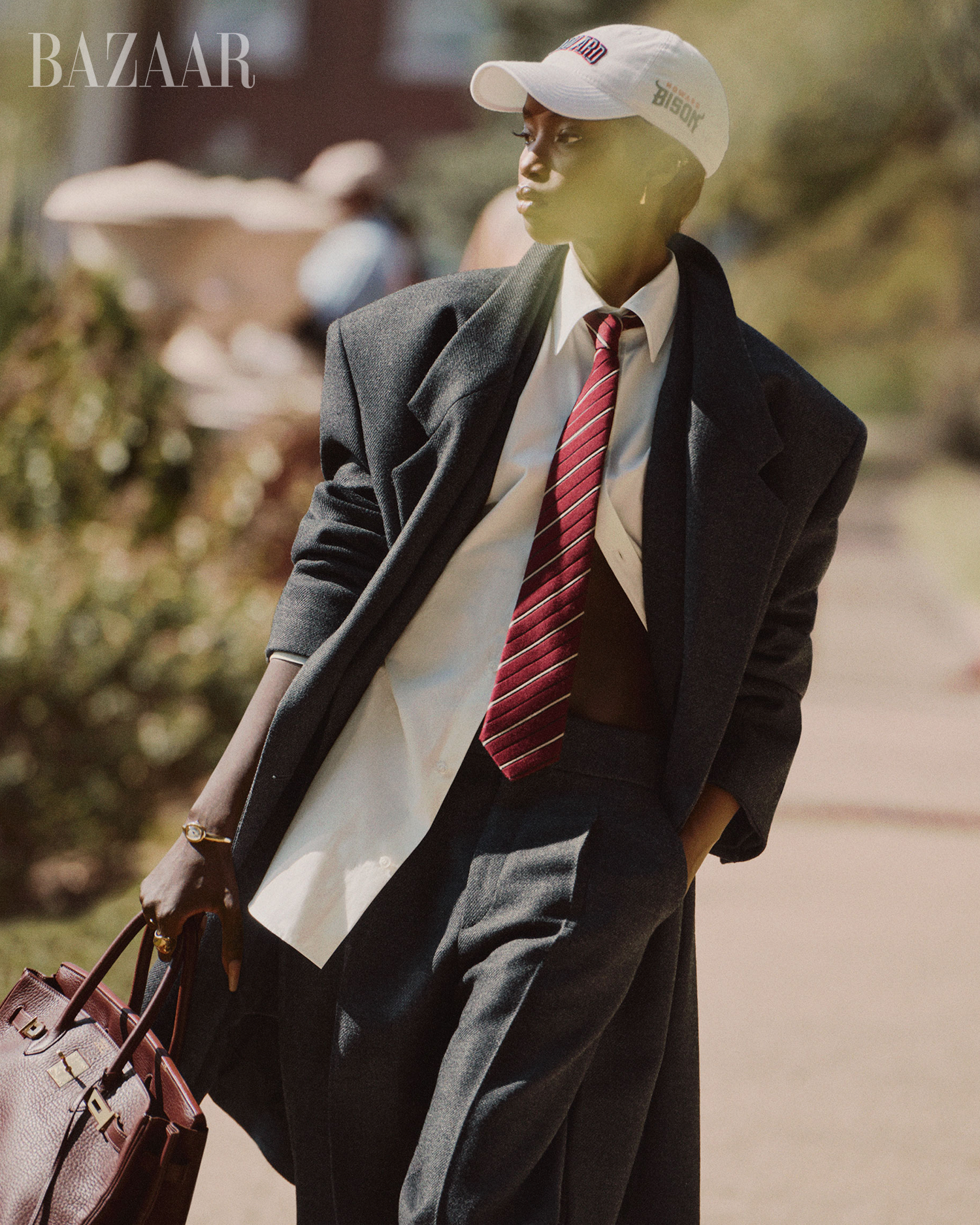 fashionable individual in formal attire with a bag