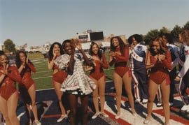 cheerleaders performing on a sports field during an event