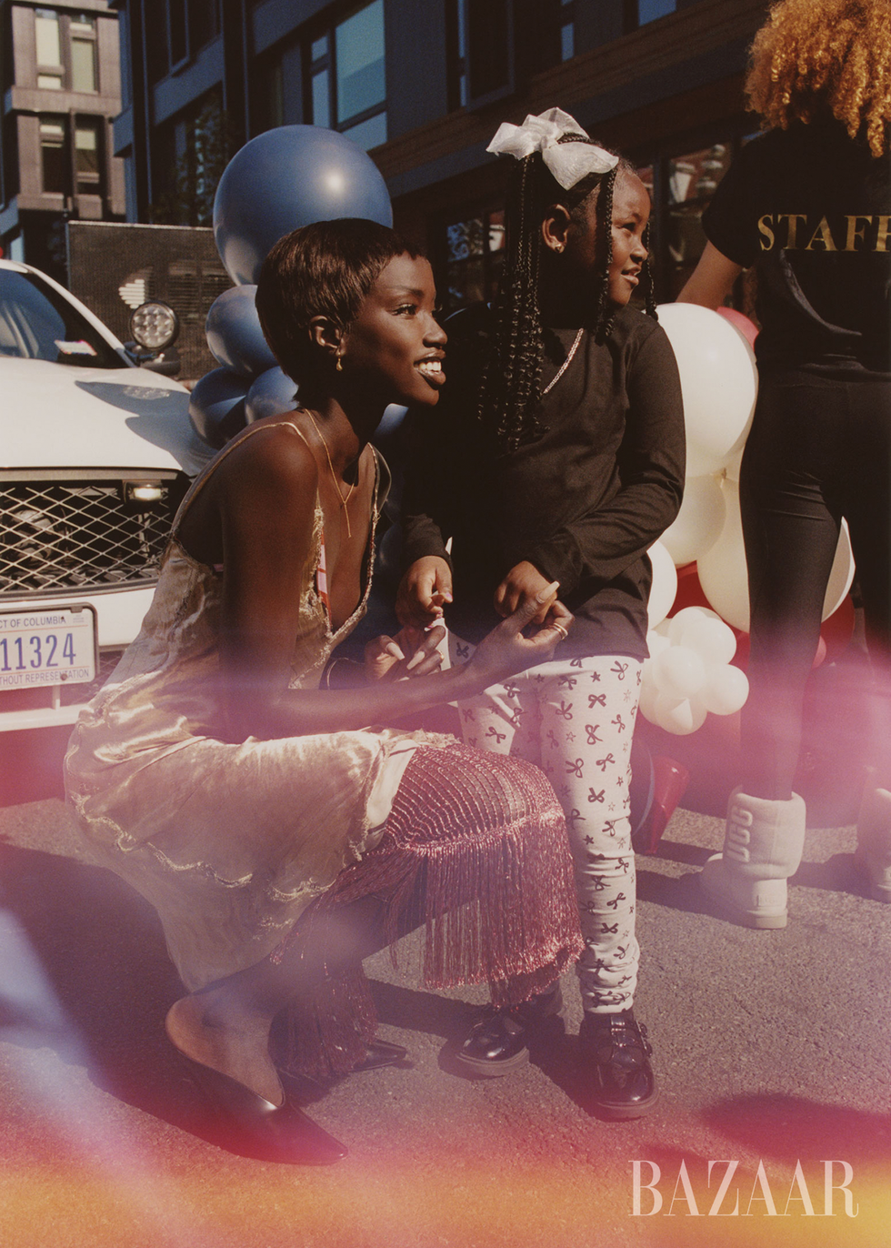 a woman interacts playfully with a child at a festive event
