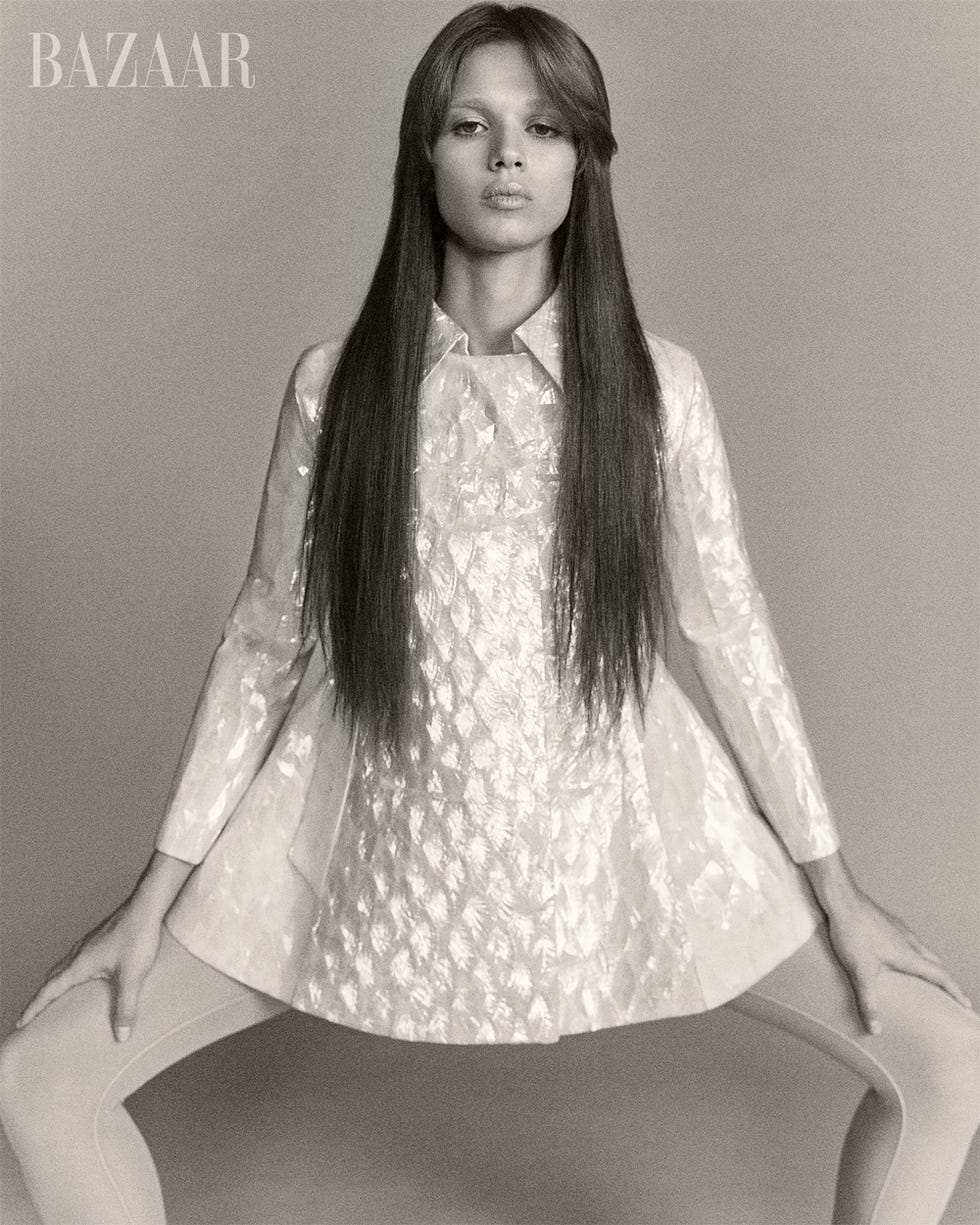 a fashion model poses in a distinctive outfit