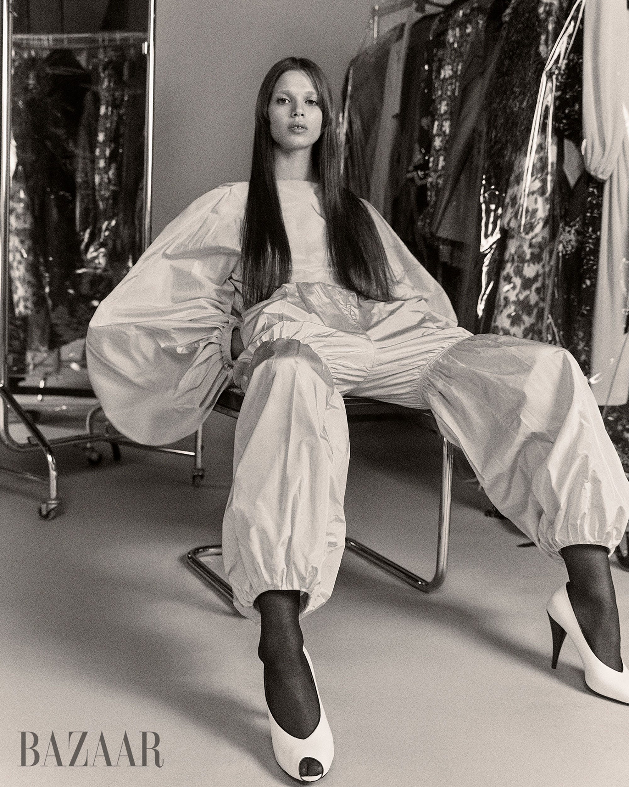 fashion model seated in a modern outfit in a dress fitting environment