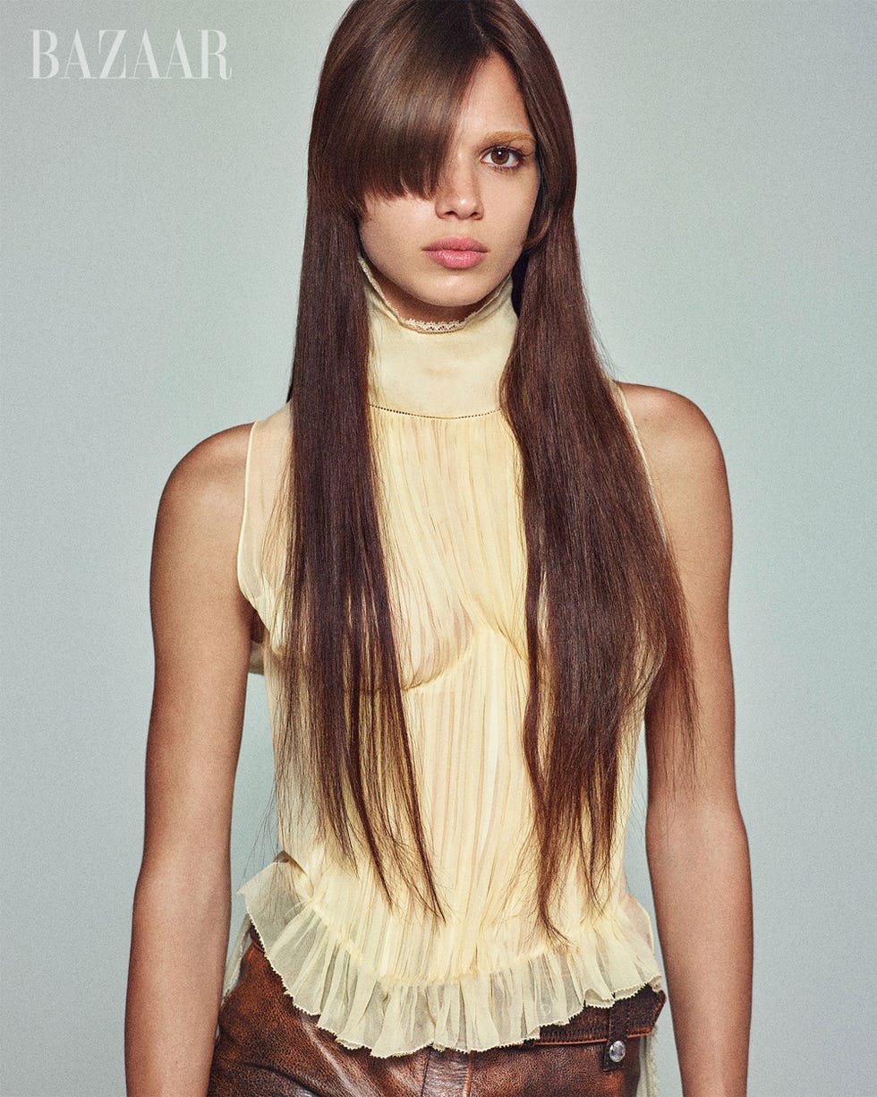 fashion editorial featuring a model in a pleated yellow top and brown leather pants