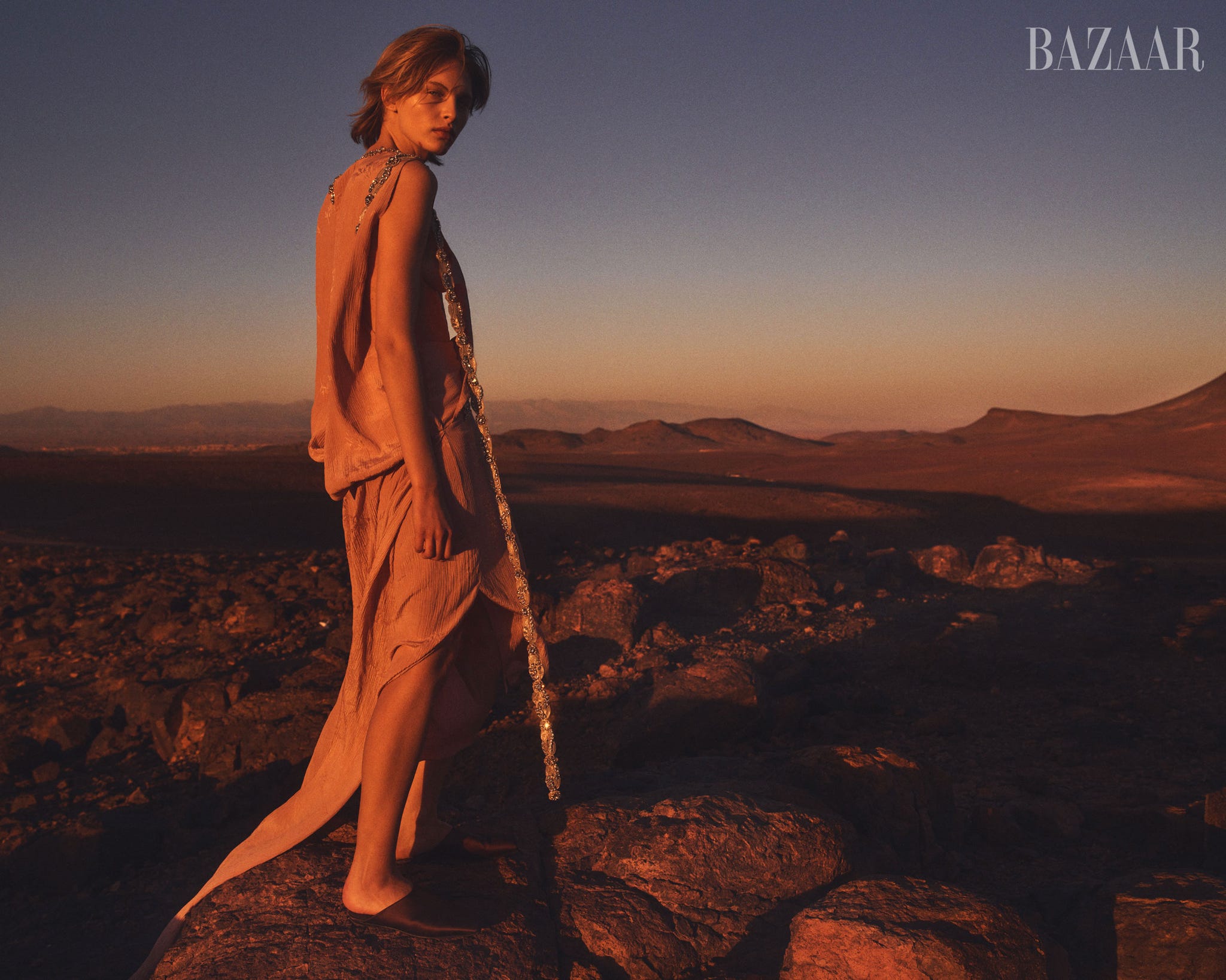 fashion model in a desert landscape during sunset
