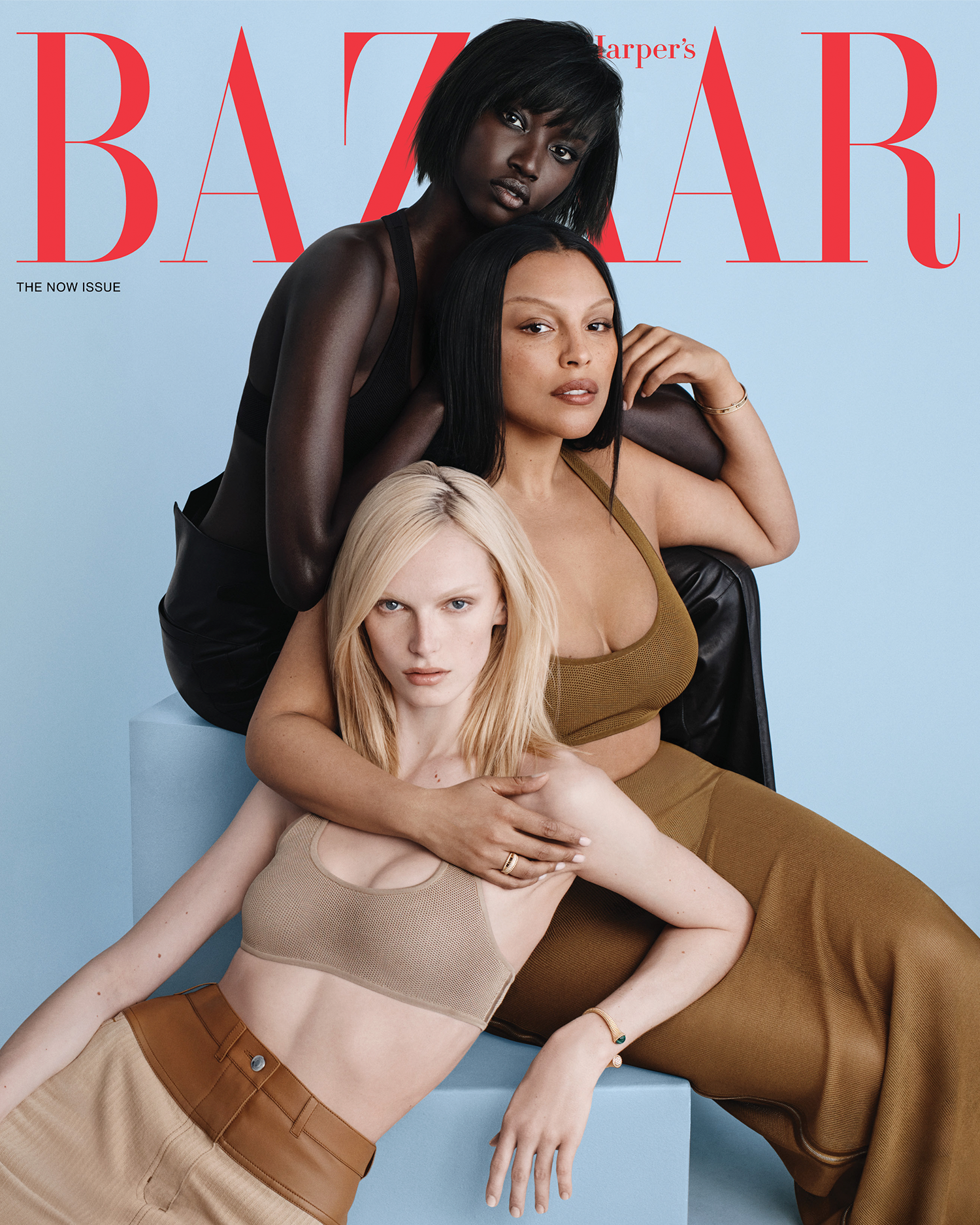 fashion magazine cover featuring three women in stylish coordinated outfits