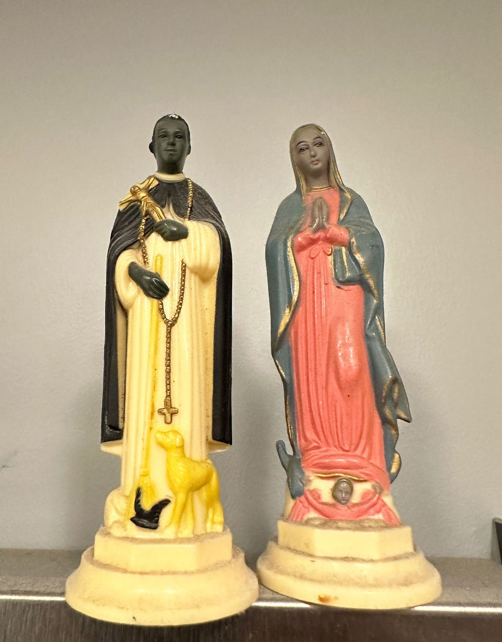 religious statues depicting a saint and the virgin mary