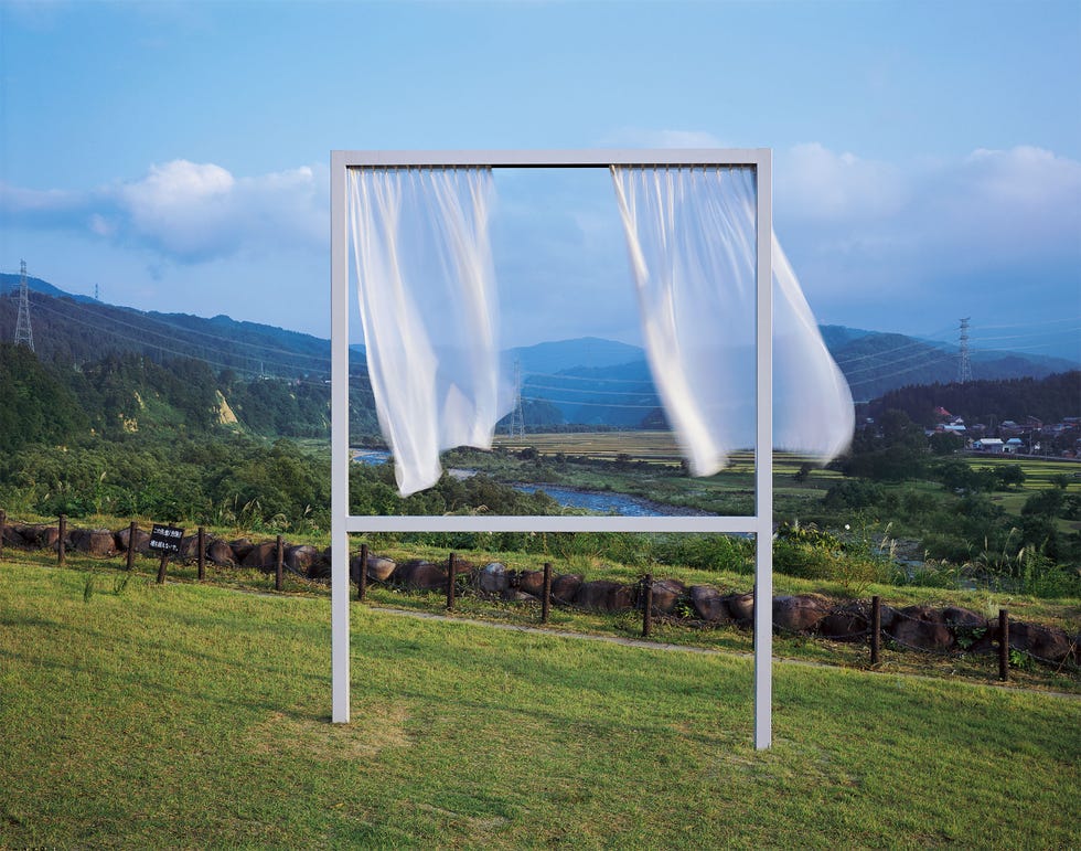 frame with flowing fabric in a natural landscape