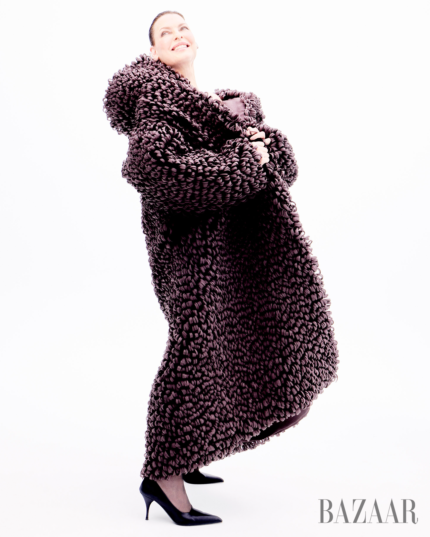 fashionable model showcasing a textured oversized coat and high heels
